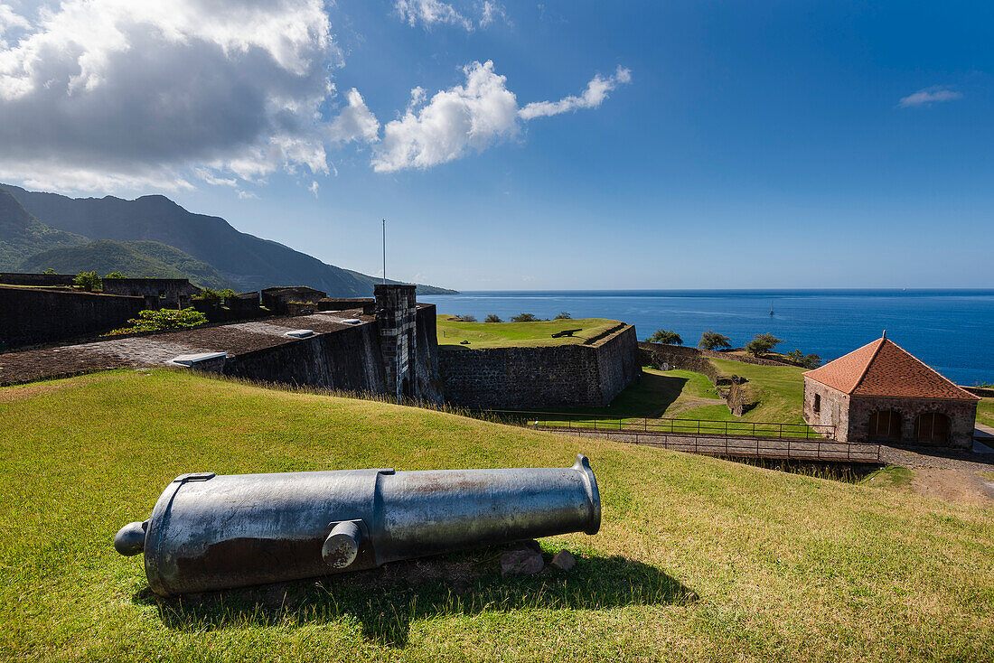 Cannon on the hillside with the drawbridge, bastion and guardhouse at Fort Louis Delgres; Basse-Terre, Guadeloupe, French West Indies