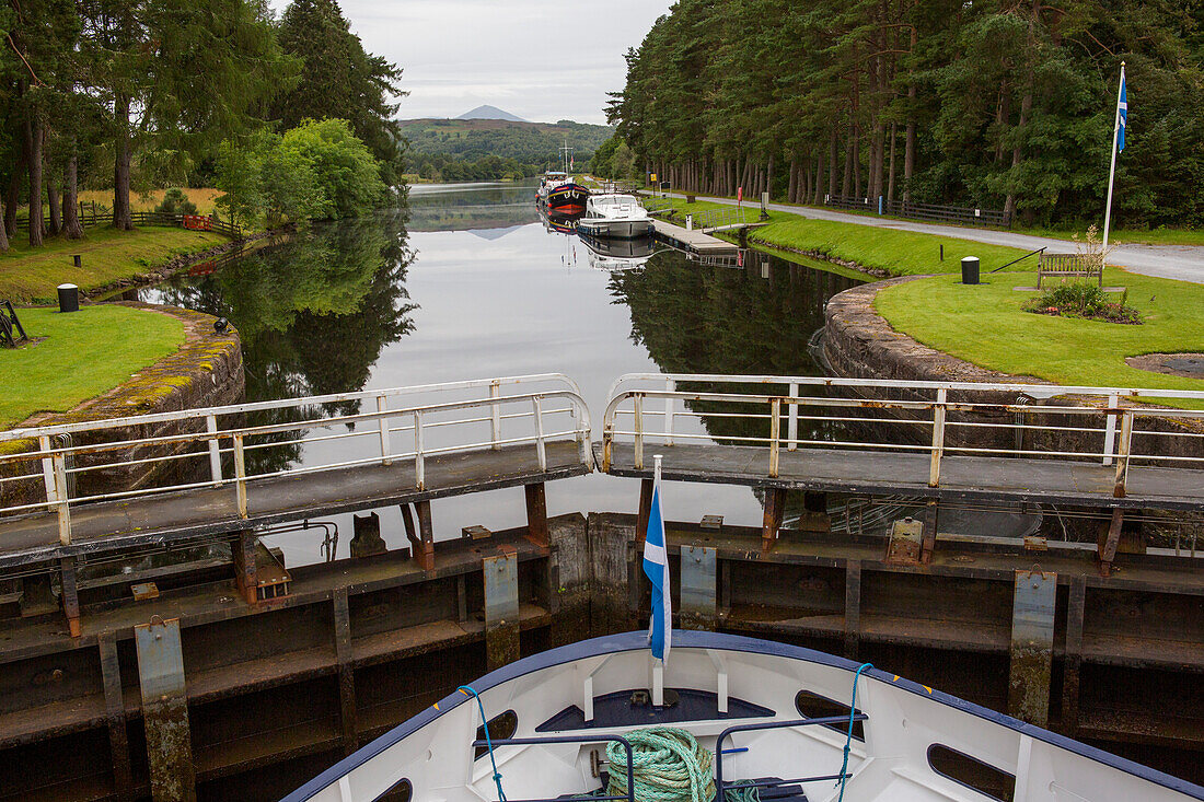 A boat pauses at lock gates along the Caledonian Canal near Kytra, Scotland; Kytra, Scotland