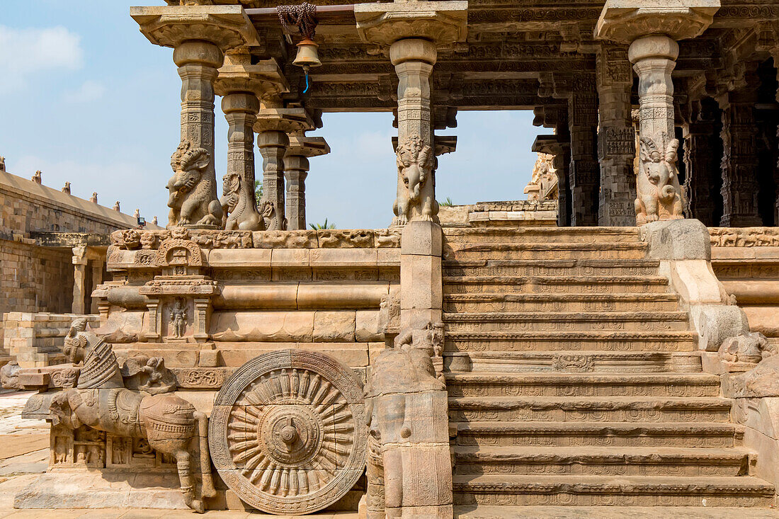 Horse drawn chariot carved in stone outside Dravidian Chola era Airavatesvara Temple with stairs leading to the interior; Darasuram, Tamil Nadu, India