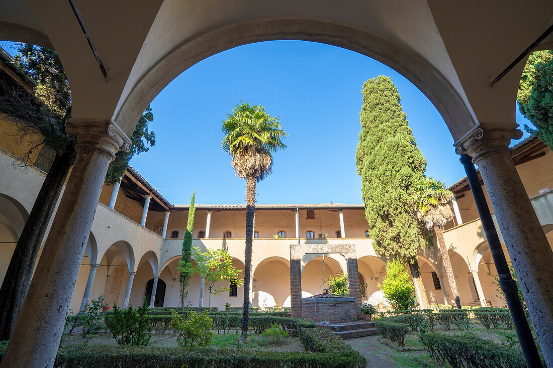 View through arch to the Courtyard and Cloister of Sant'Agostino Church; San Gimignano, Tuscany, Italy