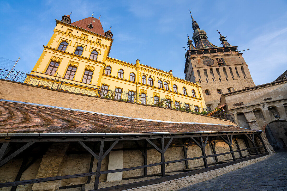 Gateway arch and clock tower of the Citadel Fortress and Old Town of Sighisoara, place of birth of Vlad Tepes (Dracula) with a blue sky; Sighisoara, Transylvania, Romania