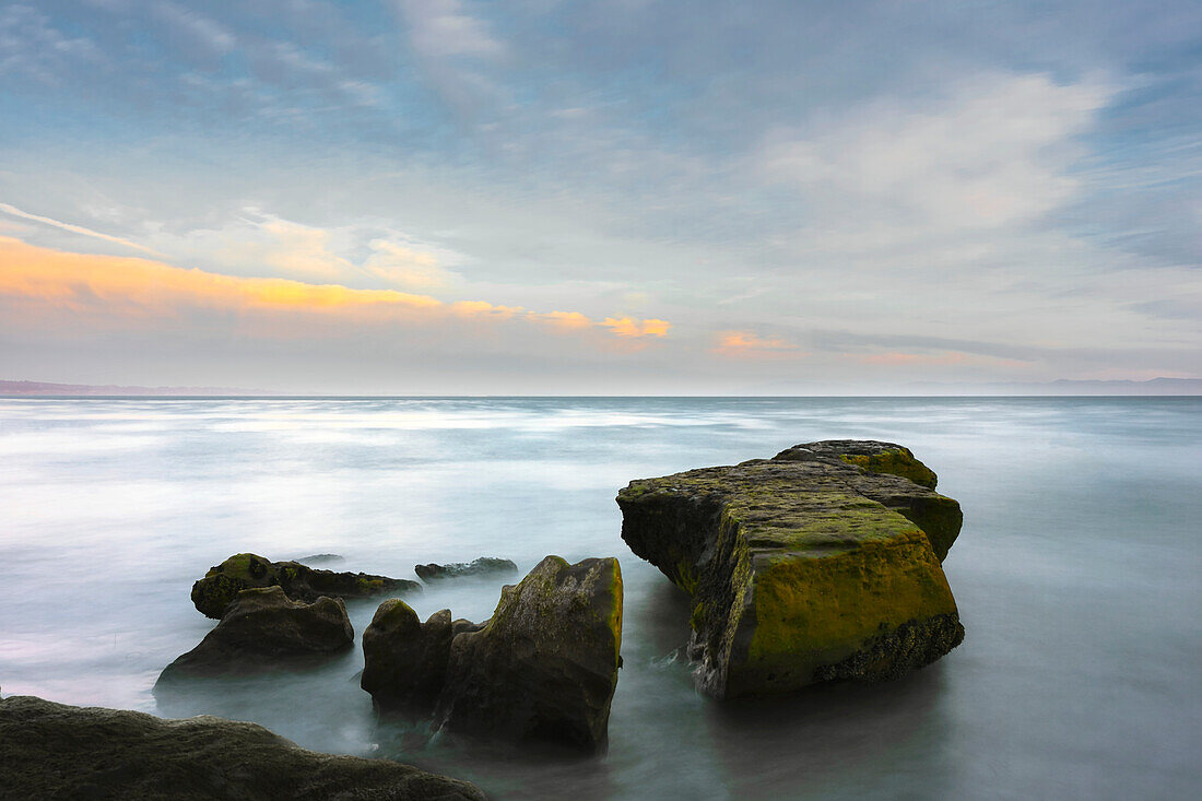 A long exposure seascape made along a rocky beach in Santa Cruz; Santa Cruz, California, United States of America