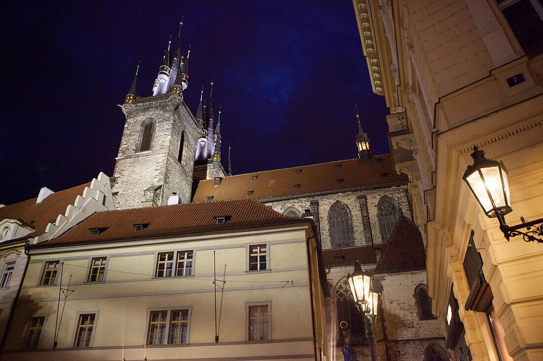 The towers and building of The Church of Our Lady before Tyn in Prague's Old Town are illuminated at twilight.; Old Town, Prague, Czech Republic