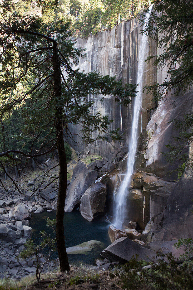Water cascades down a rock formation to a pool below at Vernal Falls.; Yosemite National Park, California