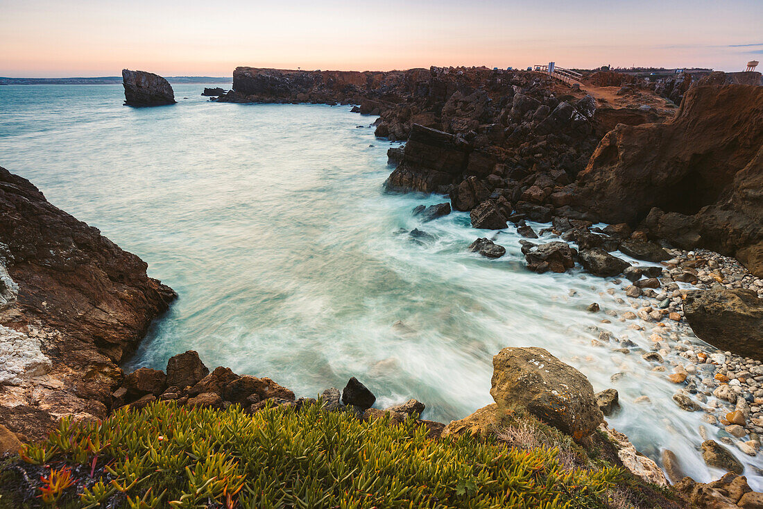 Papoa, tidal waters rushing over the rocks along the rugged coastline of Portugal; Peniche, Oeste, Portugal
