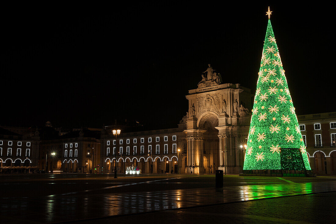 Christmas Tree decorative lights next to the Rua Augusta Arch and arcade walkway surrounding the Praca Do Comercio; Lisbon, Estremadura, Portugal