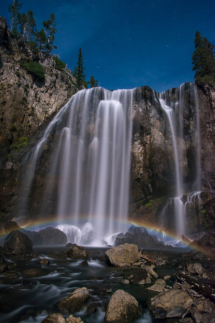 Stunning, Dunanda Falls at night with a lunar rainbow along the Boundary Creek Trail in Yellowstone National Park; Wyoming, United States of America