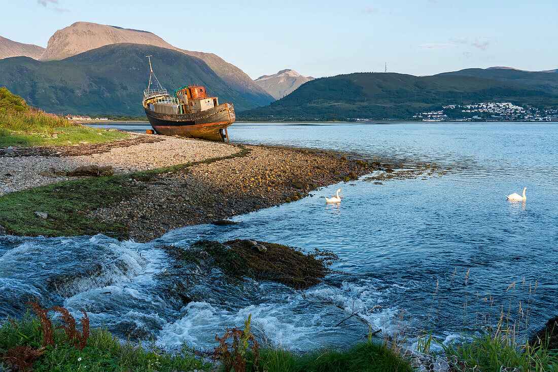 An abandoned shipwreck rests on the shoreline near Corpach and Caledonian Canal, Scotland; Corpach, Scotland