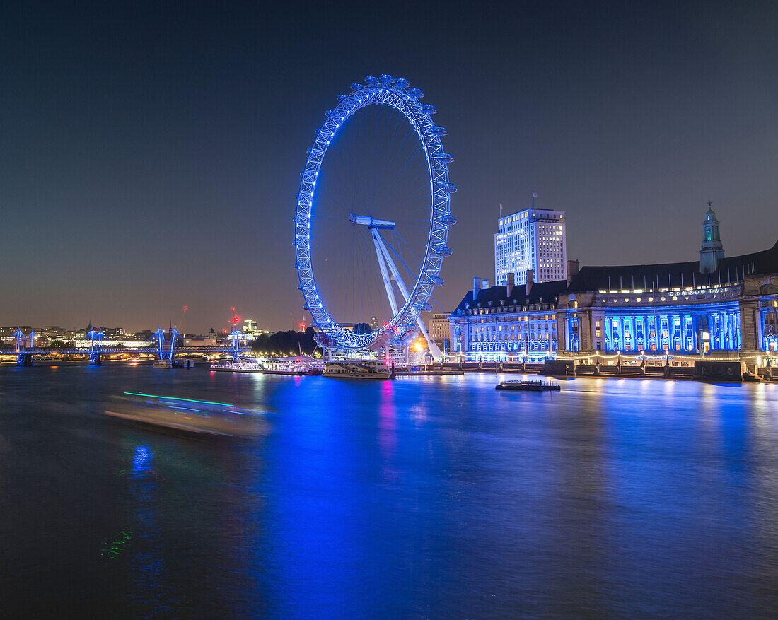 Twilight at the London Eye along the River Thames at sunset in London, England.