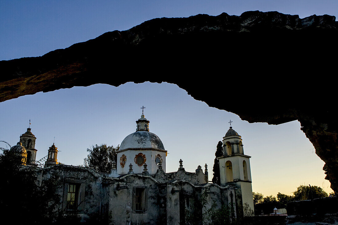 A church is viewed through an archway.