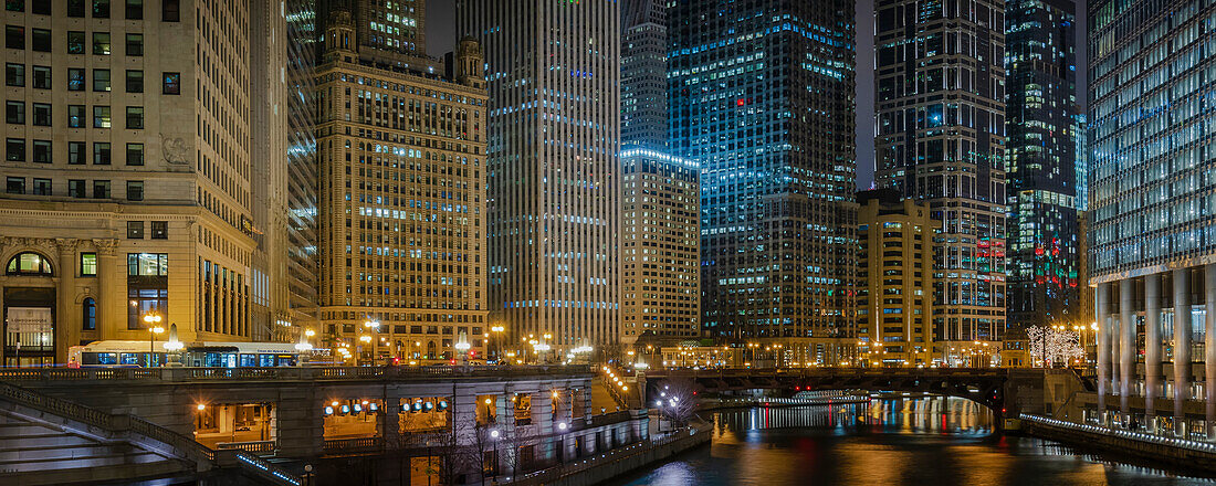 View of the Chicago River with the Wabash Avenue Bridge (Irv Kupcinet Bridge) and cityscape of iconic office towers of the City of Chicago at night; Chicago, Cook County, Illinois, United States of America