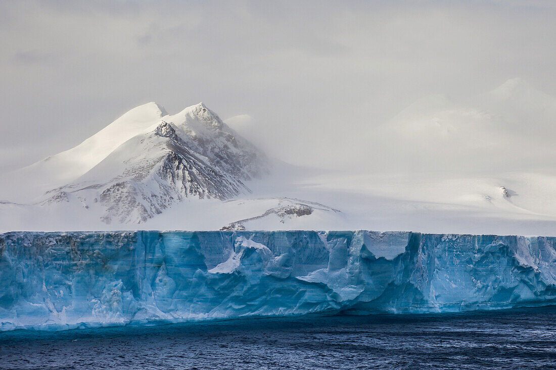 Landscape of a tabular iceberg on the ocean.