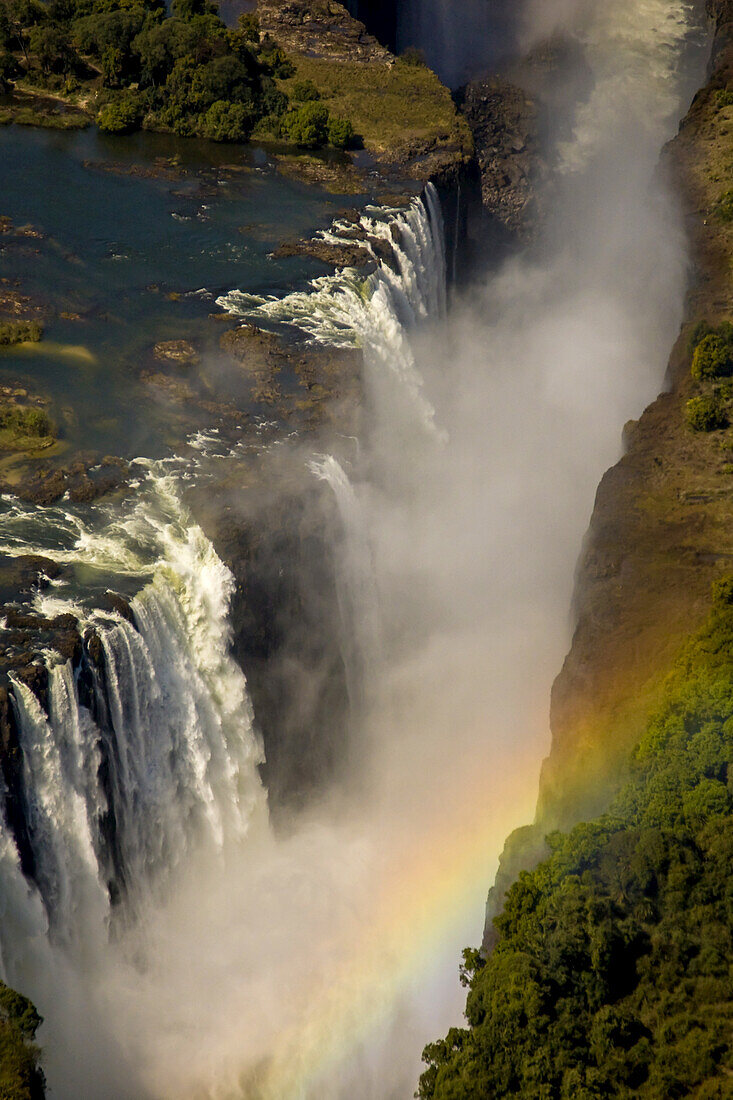 Aerial view of a rainbow over a waterfall.