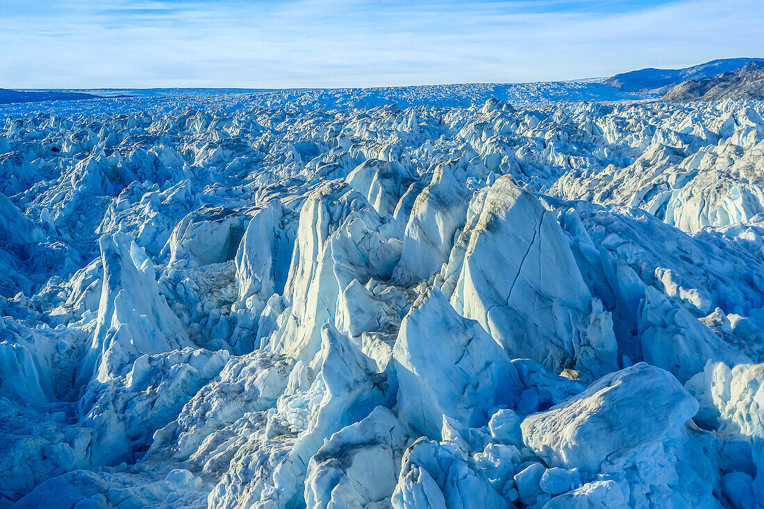 Aerial of icebergs from Helheim Glacier and Greenland Icesheet choking Sermilik Fjord.