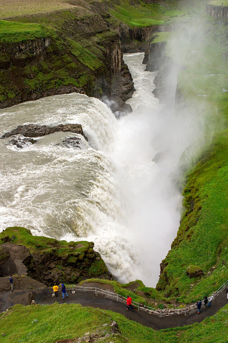 Tourist at the Gullfoss Waterfall, on the Hvita River.