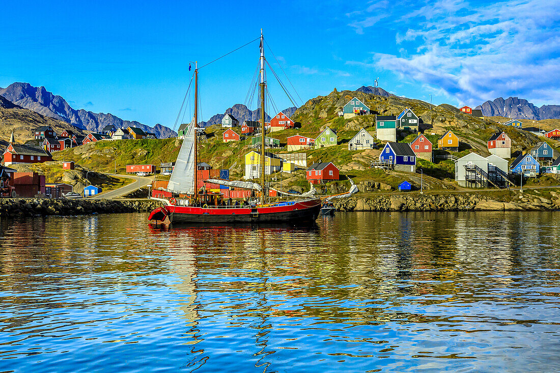 View from the water of a sailboat in the harbor of the Inuit Village of Tasiilaq (formerly Angmagssalik) in the Sermersooq municipality on the south coast of Ammassalik Island; Ammassalik Island, Greenland