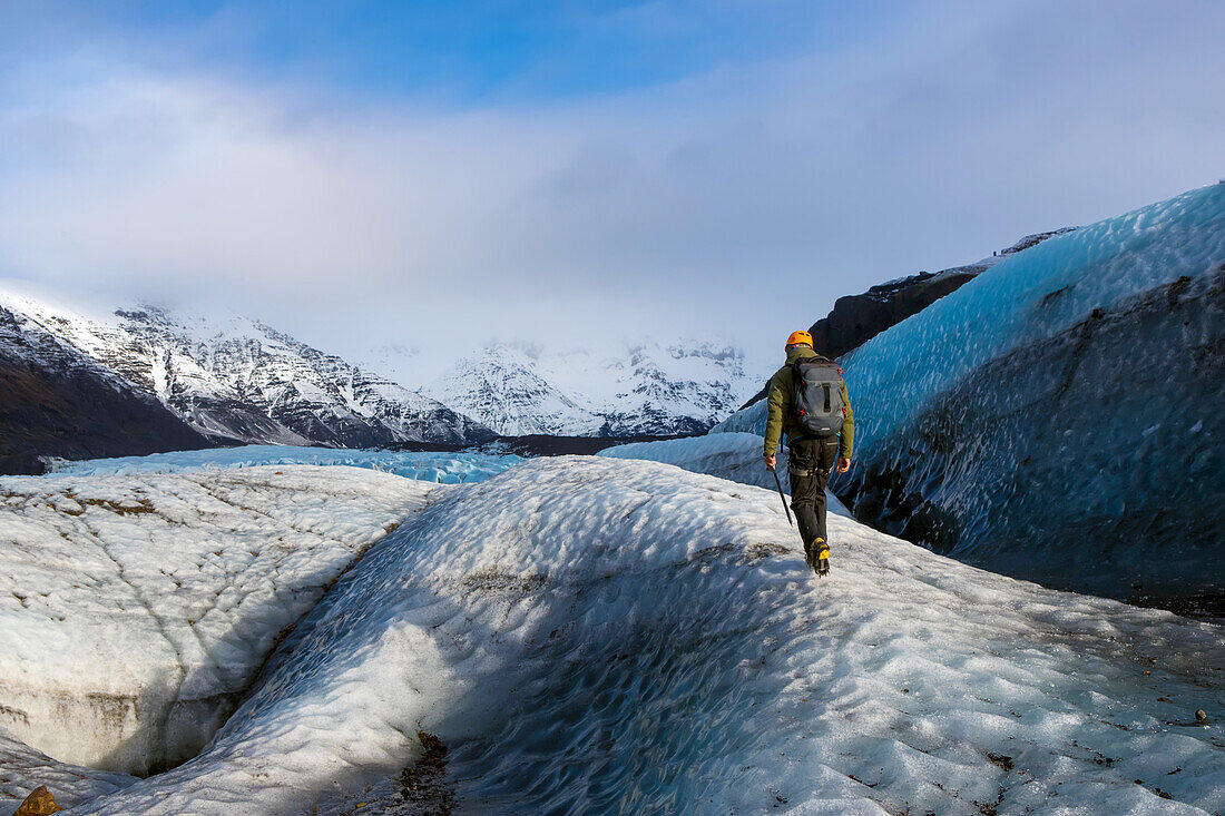 A man walks between one of many crevasses on the Vatnajokull glacier.