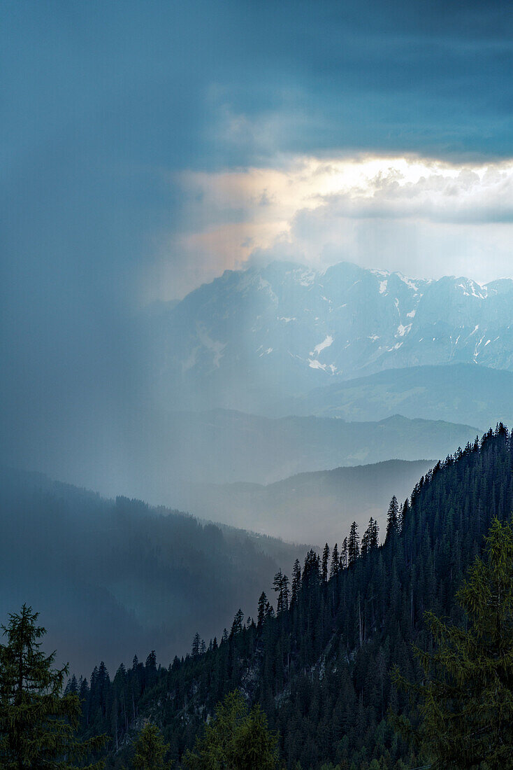 View from a summit in the Austrian Alps in the Redbull X Alps, a paragliding race, under a stormy sky; Wagrain, Salzburgerland, Austria