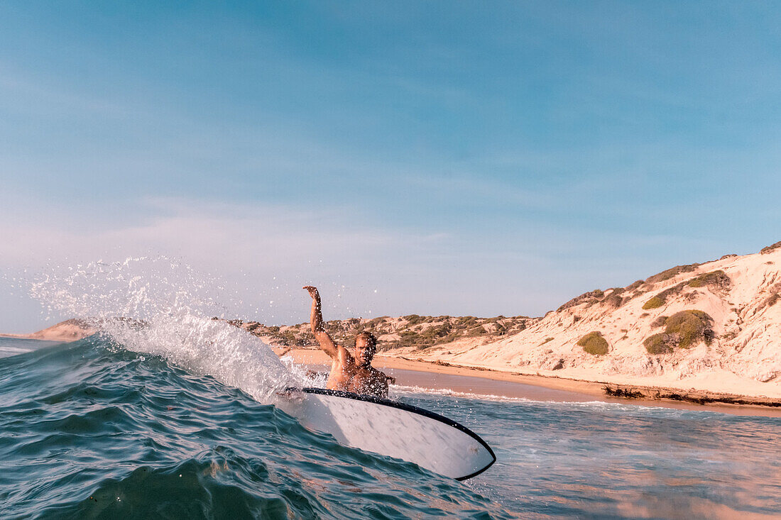 Portrait of a surfer riding the waves on the East Cape of the Baja Peninsula; Cabo San Lucas, Baja California Sur, Mexico