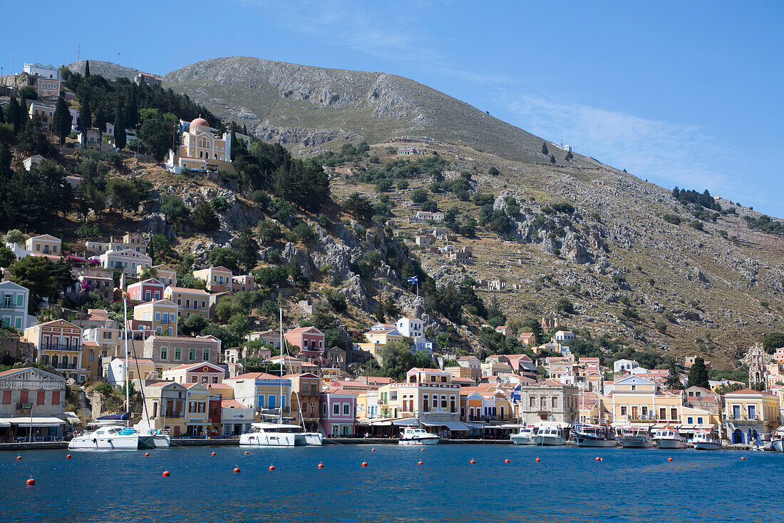 Mountainside and scenic waterfront of Gialos Harbor, Symi (Simi) Island; Dodecanese Island Group, Greece
