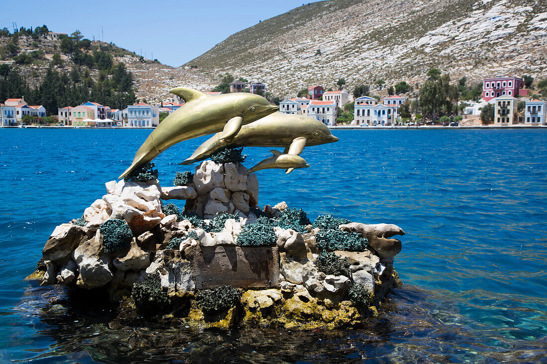 Bronze, dolphin figurines, statue, in the harbor of the historical island of Kastellorizo (Megisti) Island; Dodecanese Island Group, Greece
