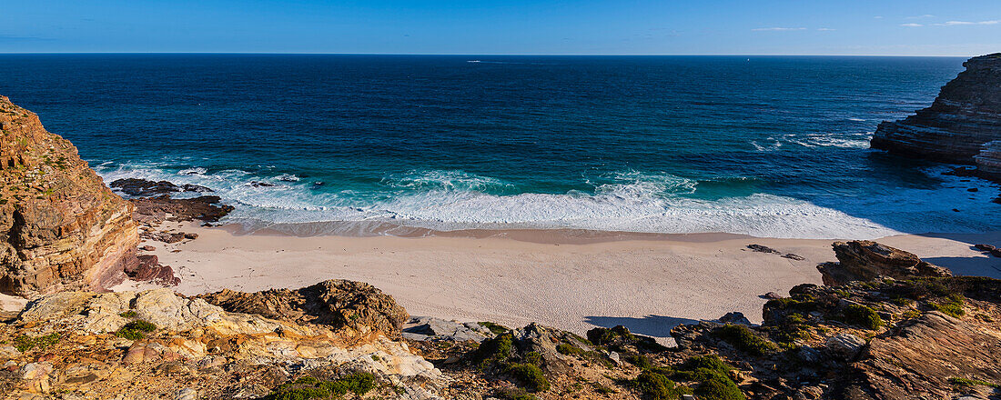 Rugged coastline and sandy beach on Diaz Beach at Cape Point along the Atlantic Ocean; Cape Town, Western Cape, South Africa