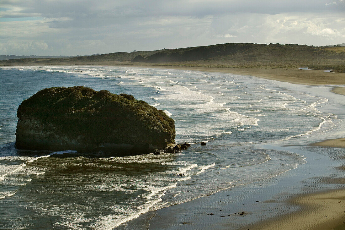 A deserted sandy bay open to Pacific surf, Patagonia, Chile.; Chiloe, in Patagonia, Chile.