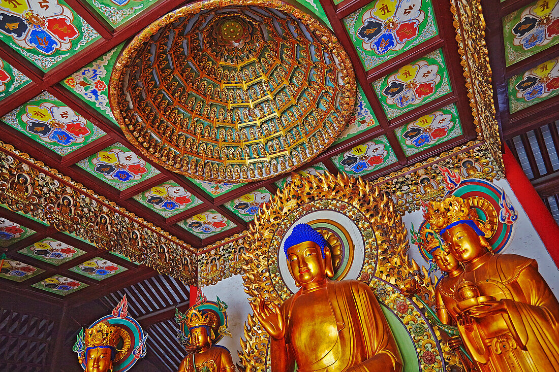 Buddha statues in the main hall at Chenxiangge Nunnery, Shanghai, China.; Nanshi, Old Town, Shanghai, China.