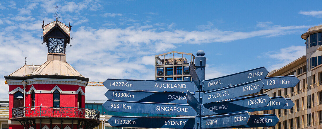 Old Clock tower and Sign Post, directional sign with the distance to various locations on the  Victoria and Alfred Waterfront in Cape Town; Cape Town, Western Cape, South Africa