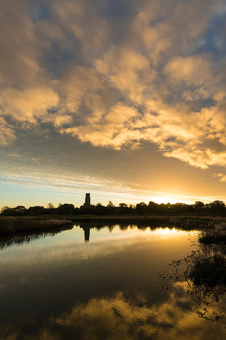 Blick über Sümpfe in der Morgendämmerung zur Blythburgh Church; Suffolk, England