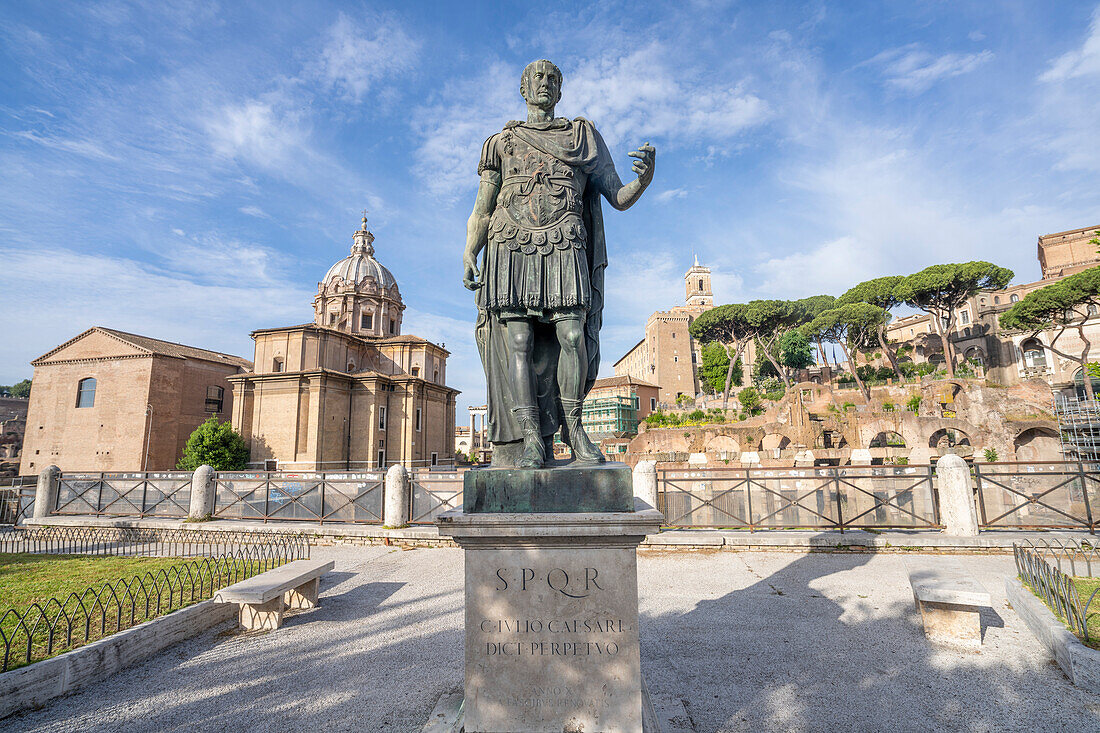 Close-up of Statua di Cesare (Statue of Julius Caesar) in front of Chiesa Santi Luca E Martina and Foro Romano ruins (Roman Forum) of Ancient Rome; Rome, Italy