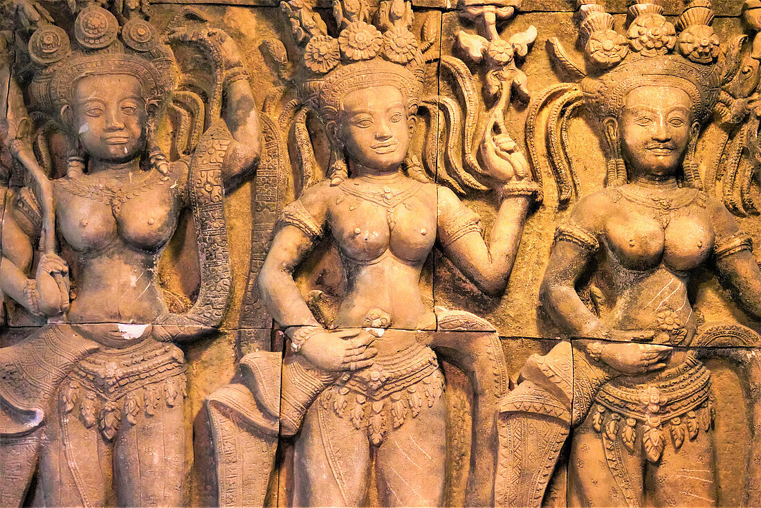Bas relief of apsaras, female dancers on a wall in Phuket; Phuket, Thailand