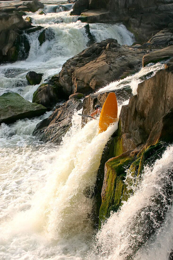 Kayaker cartwheeling over a big waterfall.; Great Falls, Potomac River, Maryland.