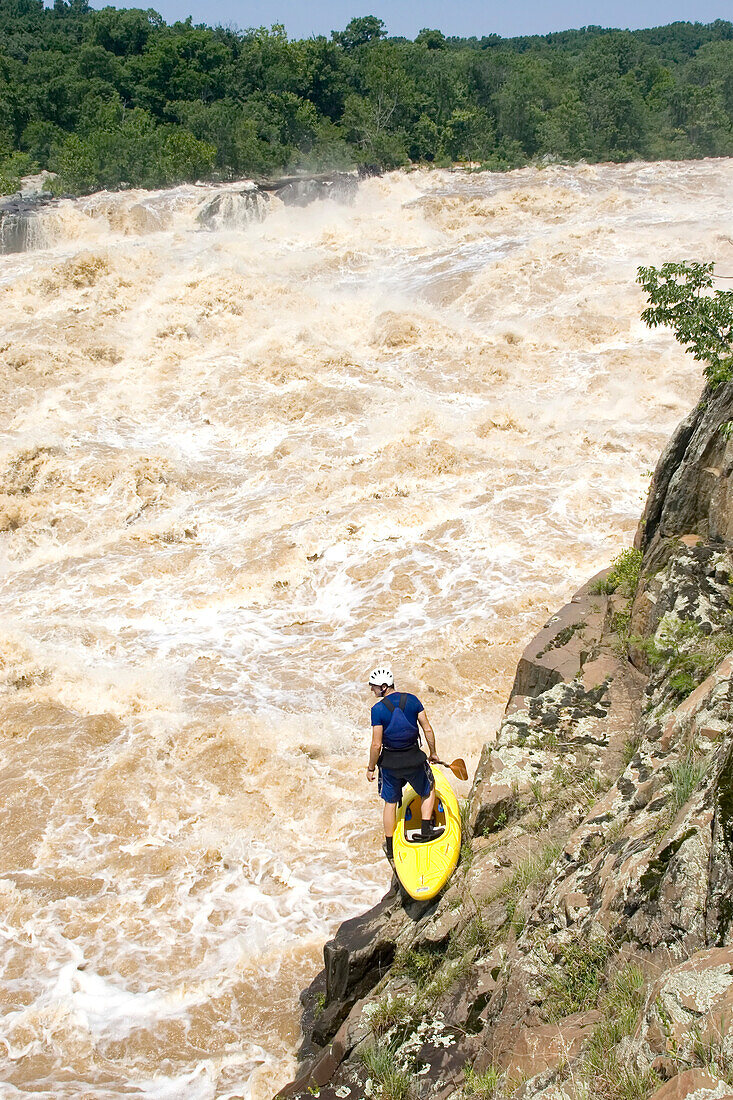 Kayaker scouts big whitewater rapids on the Potomac River; Great Falls, Potomac River, Virginia/Maryland.