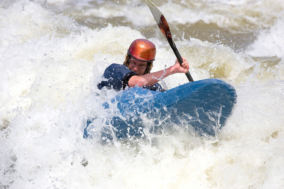 A kayaker paddles through a raging rapid on the Potomac River.; Potomac River - Maryland/Virginia, USA