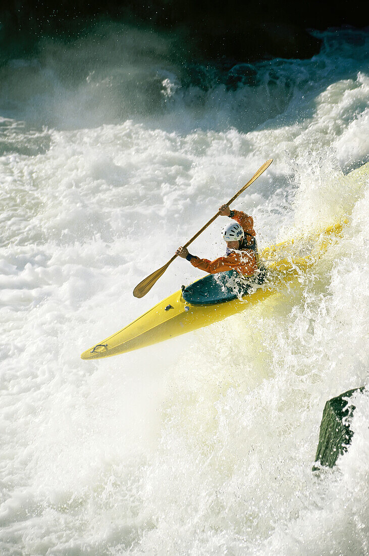 A kayaker speeds down one of the falls in the Potomac River.; Potomac River, Maryland.