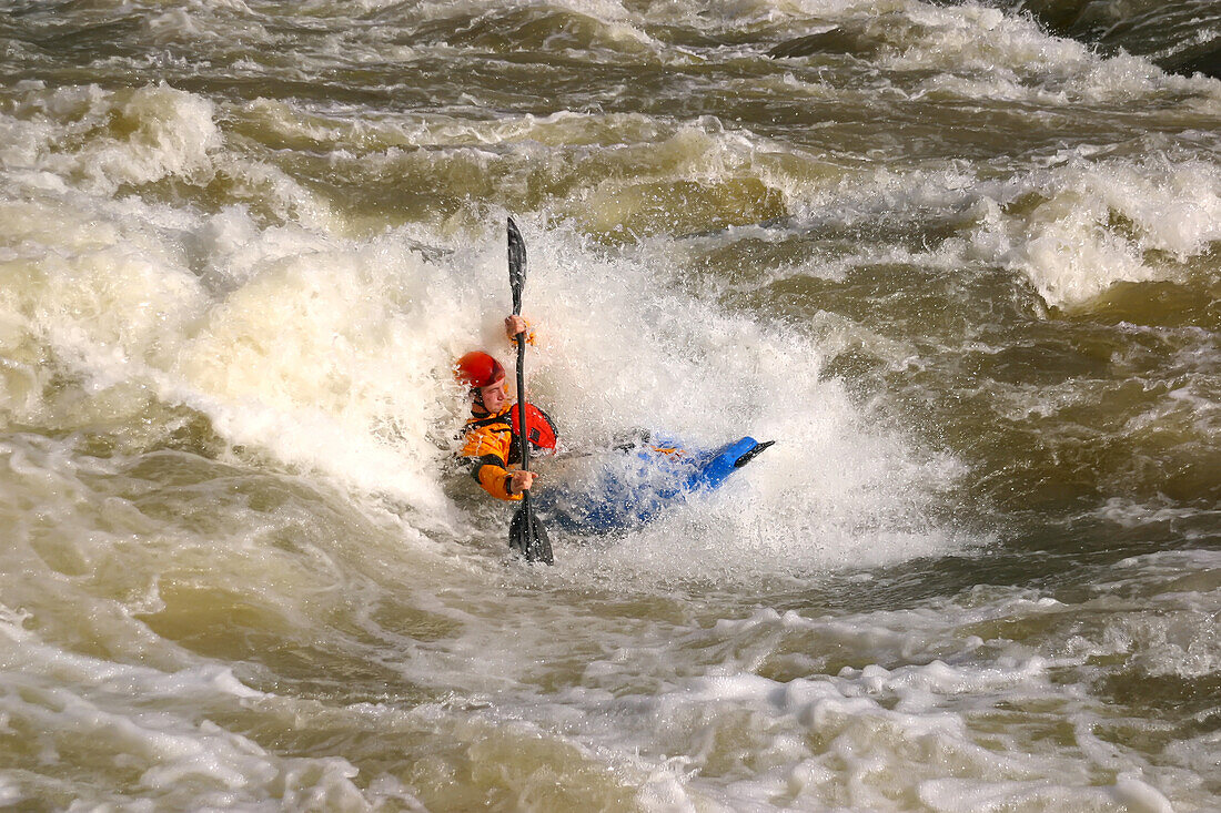A whitewater kayaker blasts a big hole at Rock Island.; Rock Island, Tennessee.