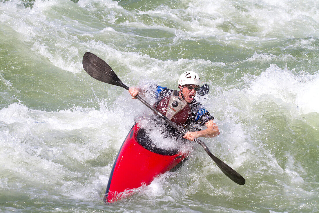 A white water slalom kayaker paddles through good white water.; Great Falls, Potomac River, Maryland/Virginia.