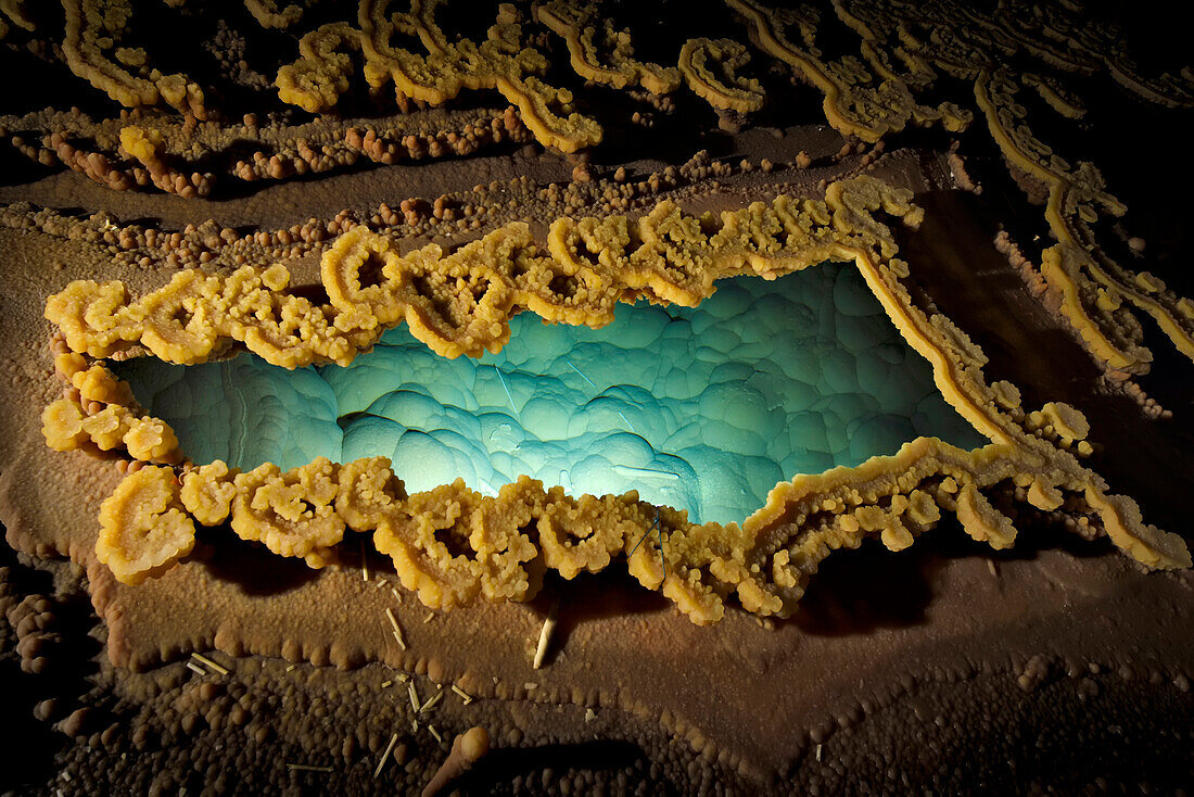 Rimstone around a gour pool of water at Lake Castrovalva inside Lechuguilla Cave.; Carlsbad Caverns National Park, New Mexico.