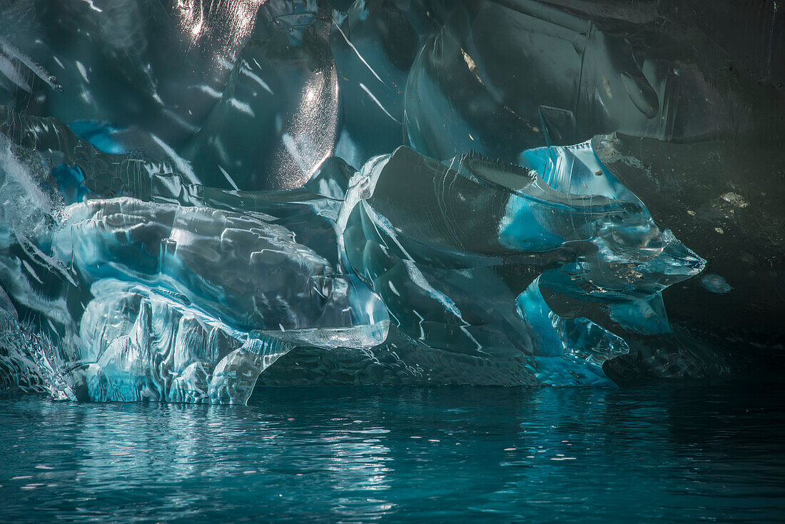 Icy enclosure at Cierva Cove, Antarctica.  The blue color of the ice results from air bubbles out of the ice over a long period, increasing the density so that it more efficiently absorbs colors other than blues; Antarctica