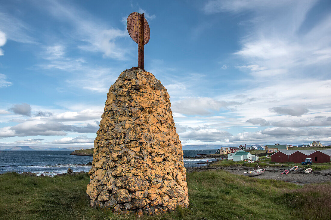 Stone formation with radar reflector on hilltop overlooking the harbor on Flatey Island, part of a cluster of about forty large and small islands and islets located in Breiðafjörður on the northwestern part of Iceland; Western Islands, Iceland