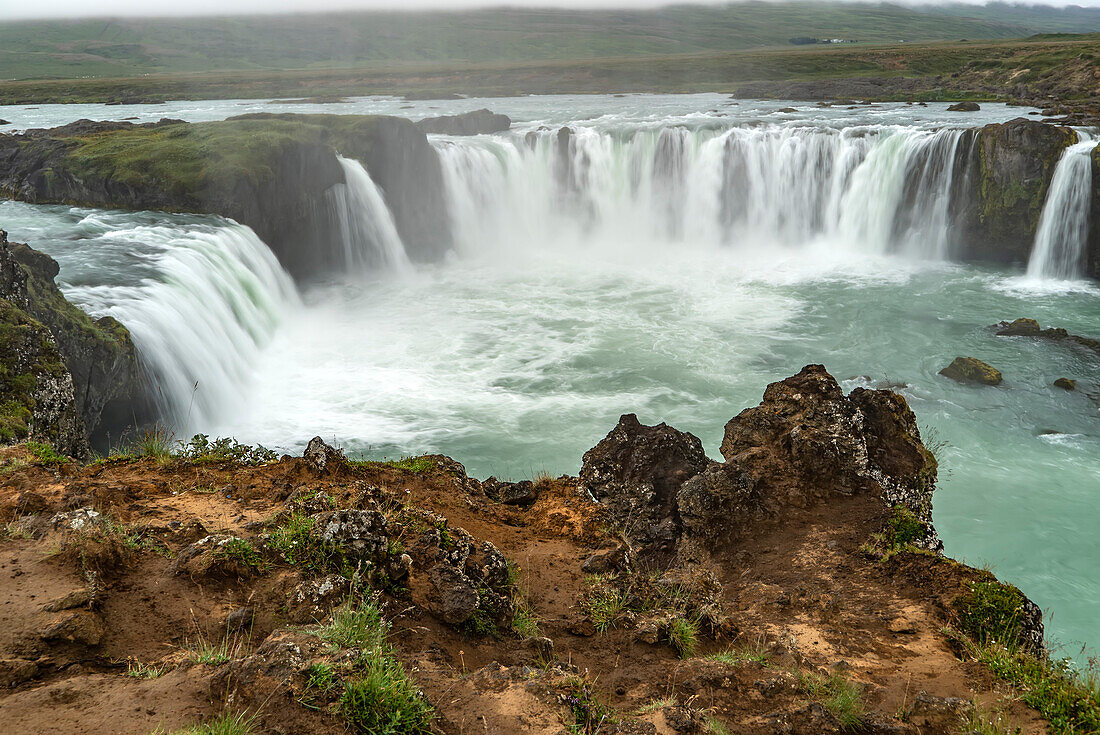 Overview of Goðafoss Waterfall. Godafoss is in Northern Iceland about 45 minutes from Akureyri, Iceland's second largest city. The water, from the river Skjálfandafljót falls from a height of 36 feet; North Central Region, Iceland