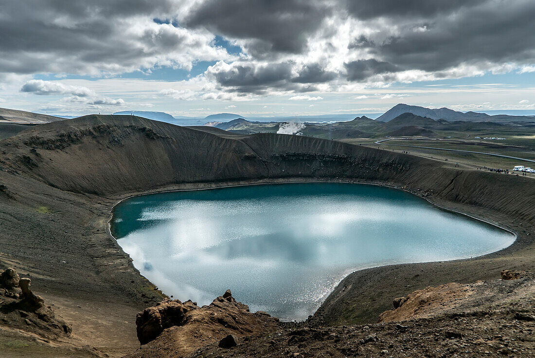 Turquoise waters of Viti Lake in the Viti Crater of Krafla. Krafla is a volcanic caldera of about 10 km in diameter with a 90 km long fissure zone. It is located in the North of Iceland in the Mývatn Region and is situated on the Iceland hotspot atop the Mid-Atlantic Ridge, which forms the divergent boundary between the North American Plate and the Eurasian Plate; Viti Crater, Krafla, Lake Myvatn Region, Iceland