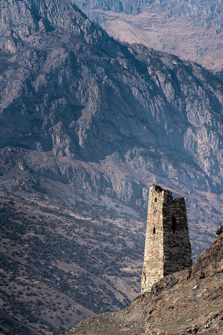 Towers of silence on the mountainside in Ingushetia, against mountain backdrop; Republic of Ingushetia, Russia