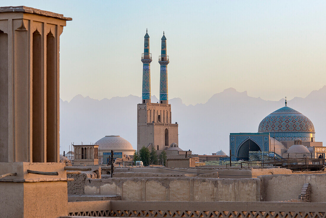 Overview of Jamesh Mosque of Yazd at sunset with the soft silhouette of the Zagros Mountain in the distance; Yazd City, Yazd Province, Iran