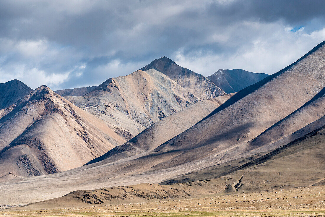 View of the Tibetan plateau with stark mountain peaks and slopes; Tibetan Autonomous Region, Tibet