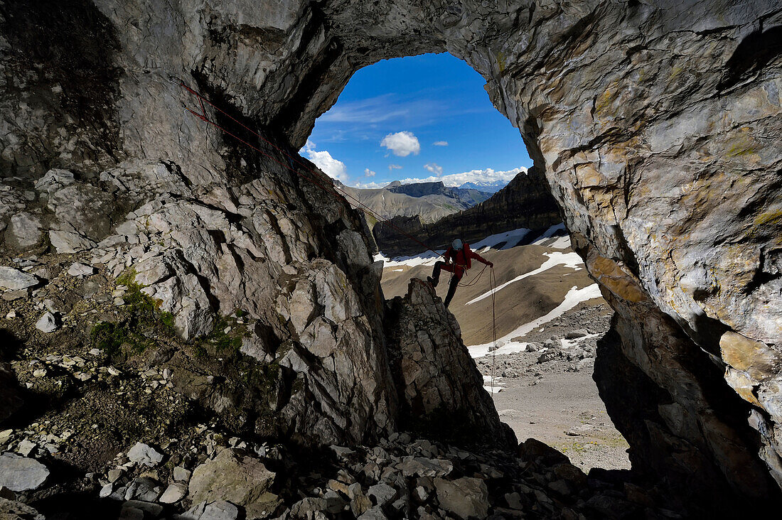 A scientist prepares to climb into the entrance of Leclanche Cave in the Sanetsch area of Switzerland.