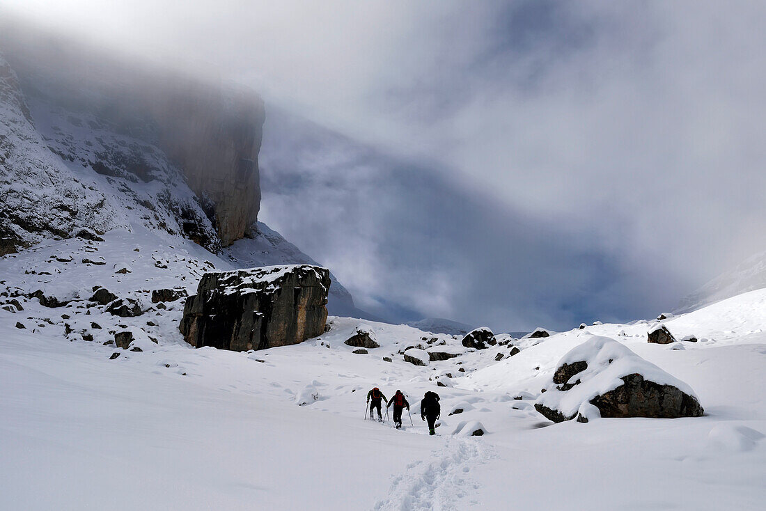 An expedition team hikes to document a cave called El Cenote inside Conturines Spitze.