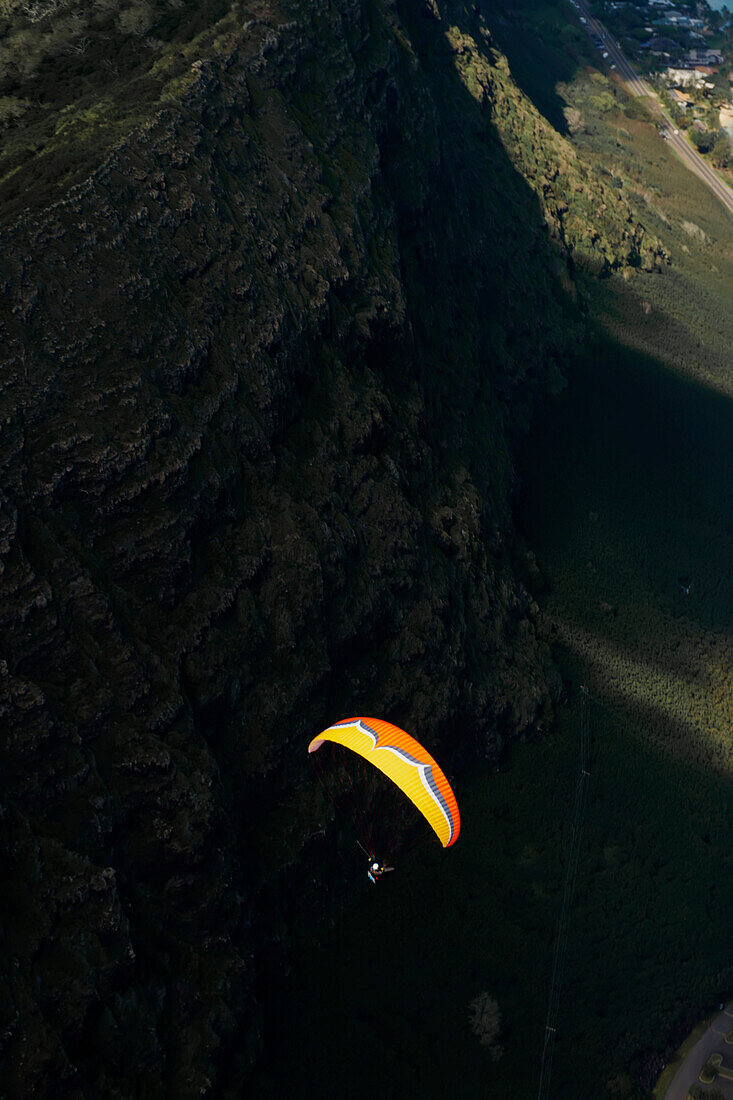 Gleitschirmflieger hoch über den Berggipfeln bei Honolulu; Oahu, Hawaii, Vereinigte Staaten von Amerika