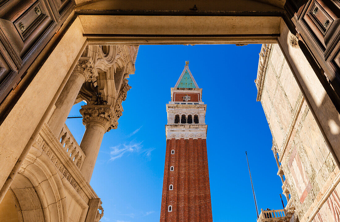 View of St Mark's Campanile through a rectangular archway at Doge's Palace in Piazza San Marco; Veneto, Venice, Italy